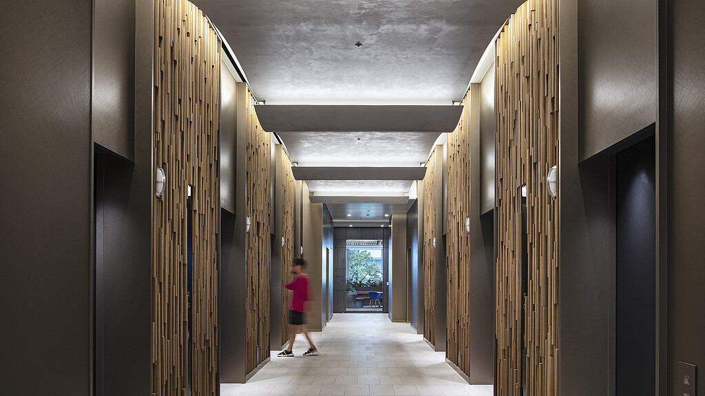 A person walking through a hallway.